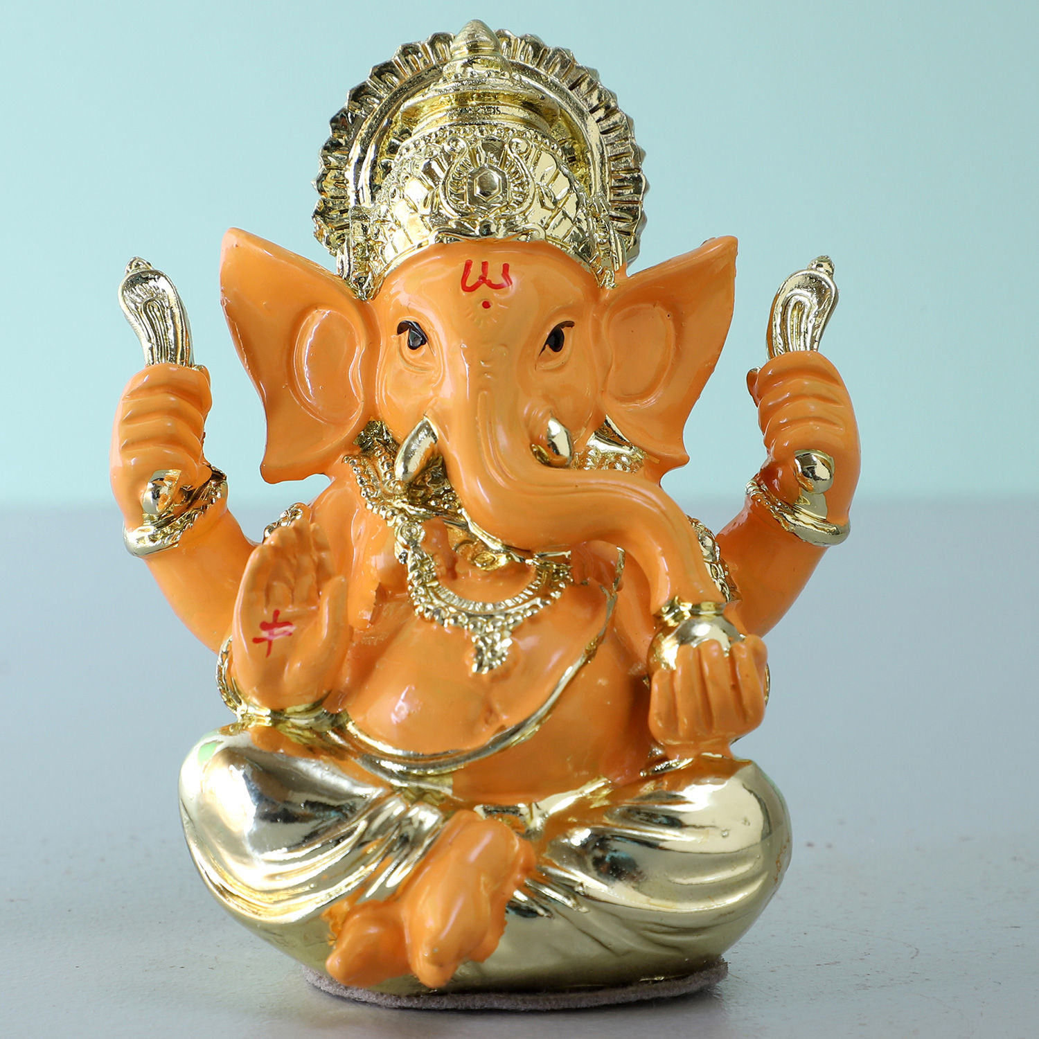 Online Gold Plated Orange Ganesha Idol Gift Delivery in UAE FNP